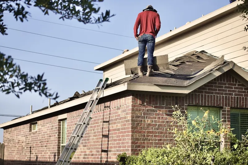 Professional roofer working on a residential roof in Dignowity Hill